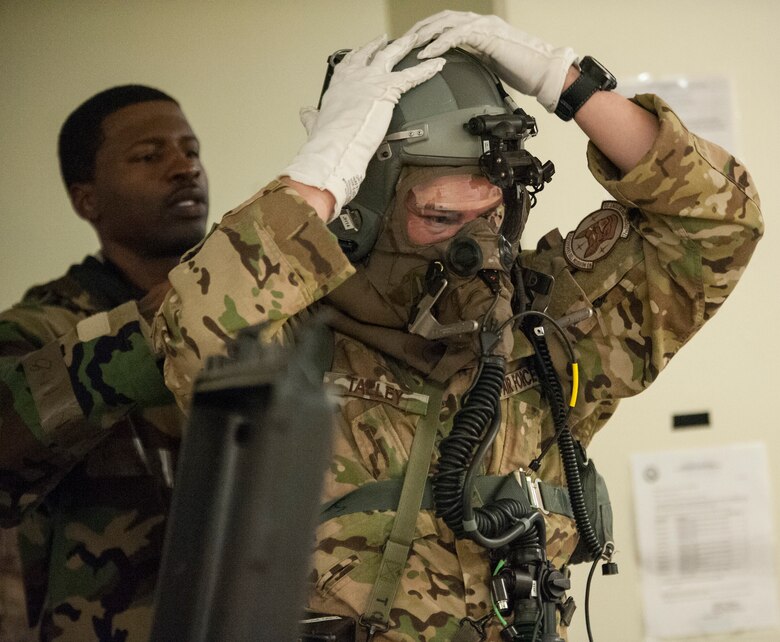 Aircrew conduct inflight training with protective gear > Air Force