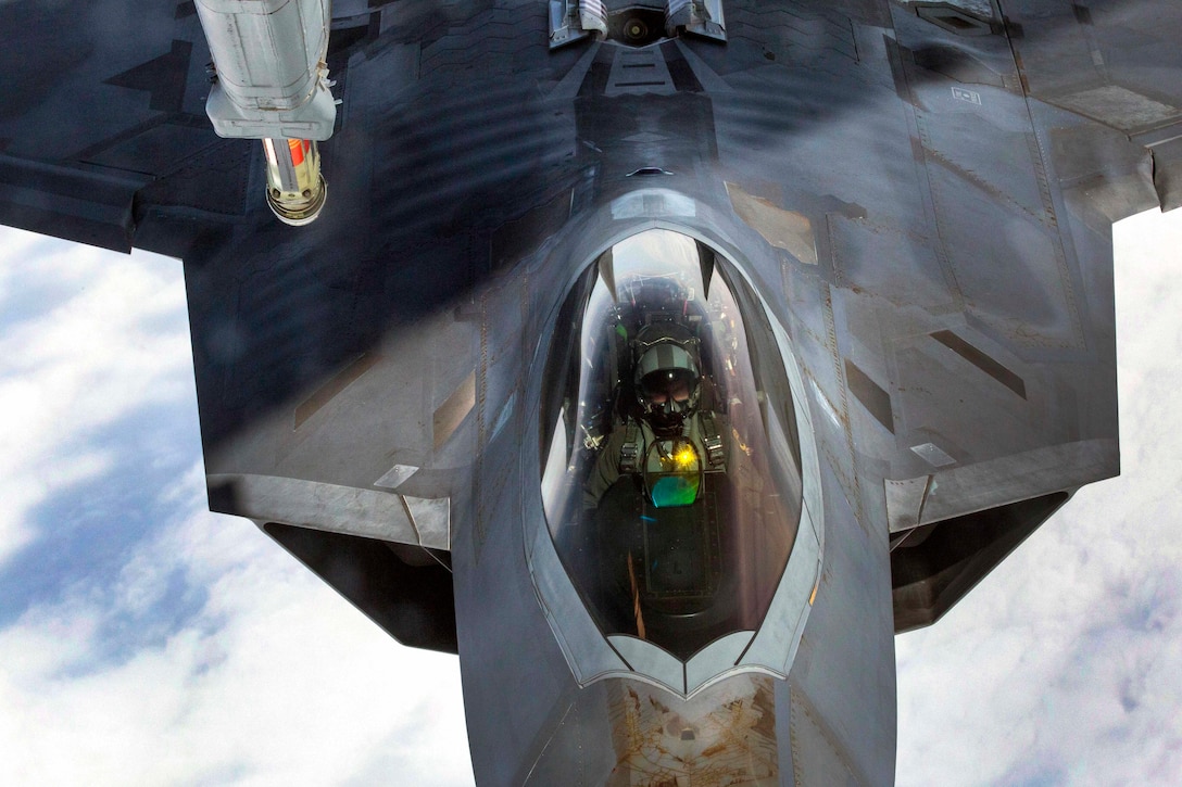 An Air Force F-22 Raptor moves into position for refueling by a KC-10 Extender over the Atlantic Ocean.
