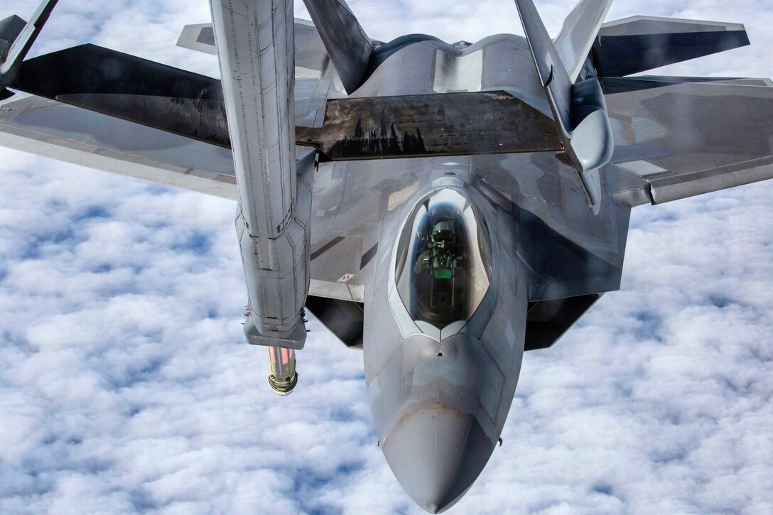 An Air Force F-22 Raptor moves into position for refueling by a KC-10 Extender.