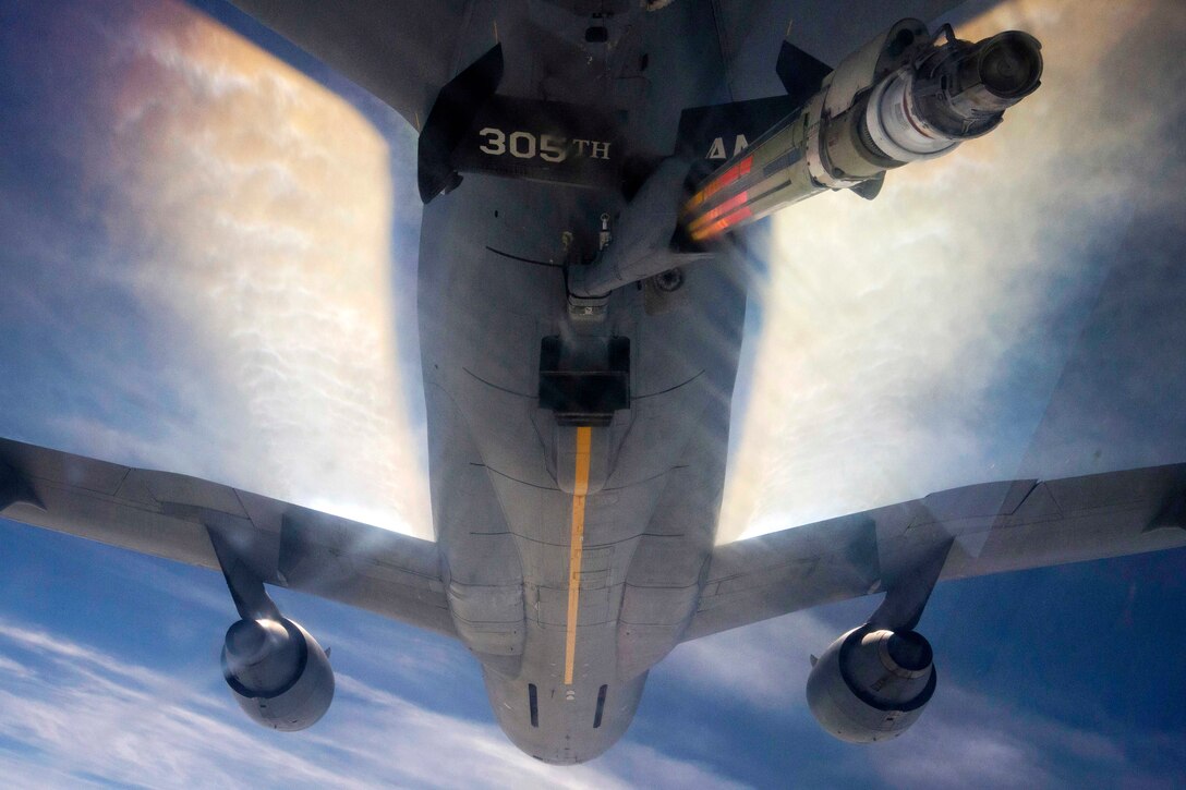 A KC-10 Extender flies away after refueling an Air Force F-22 Raptor.