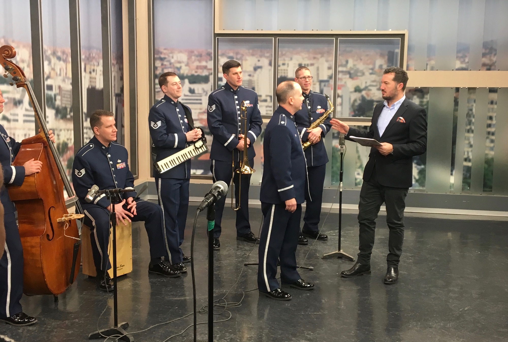 The U.S. Air Forces in Europe Band Commander, Lt. Col. Don Schofield, speaks to the Radio Television of Kosovo morning show host during a live broadcast in Pristina, Kosovo, Feb. 16, 2018. The band was in Kosovo to celebrate the 10th anniversary of Kosovo independence. (U.S. Air Force photo by Maj. Tristan Hinderliter)