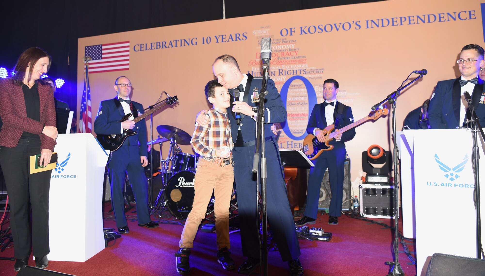 The U.S. Air Forces in Europe Band Commander, Lt. Col. Don Schofield, presents a souvenir baseball to a local child during a concert at Red Hall in Pristina celebrating the country’s 10th anniversary of independence, Feb. 16, 2018. The event was hosted by the U.S. Ambassador to Kosovo, Greg Delawie, and broadcast live on Radio Television of Kosovo, the most-viewed television station in the country. The audience included diplomats, members of the Kosovo Security Forces and dozens of young Kosovars invited by the embassy. (U.S. Air Force photo by Maj. Tristan Hinderliter)