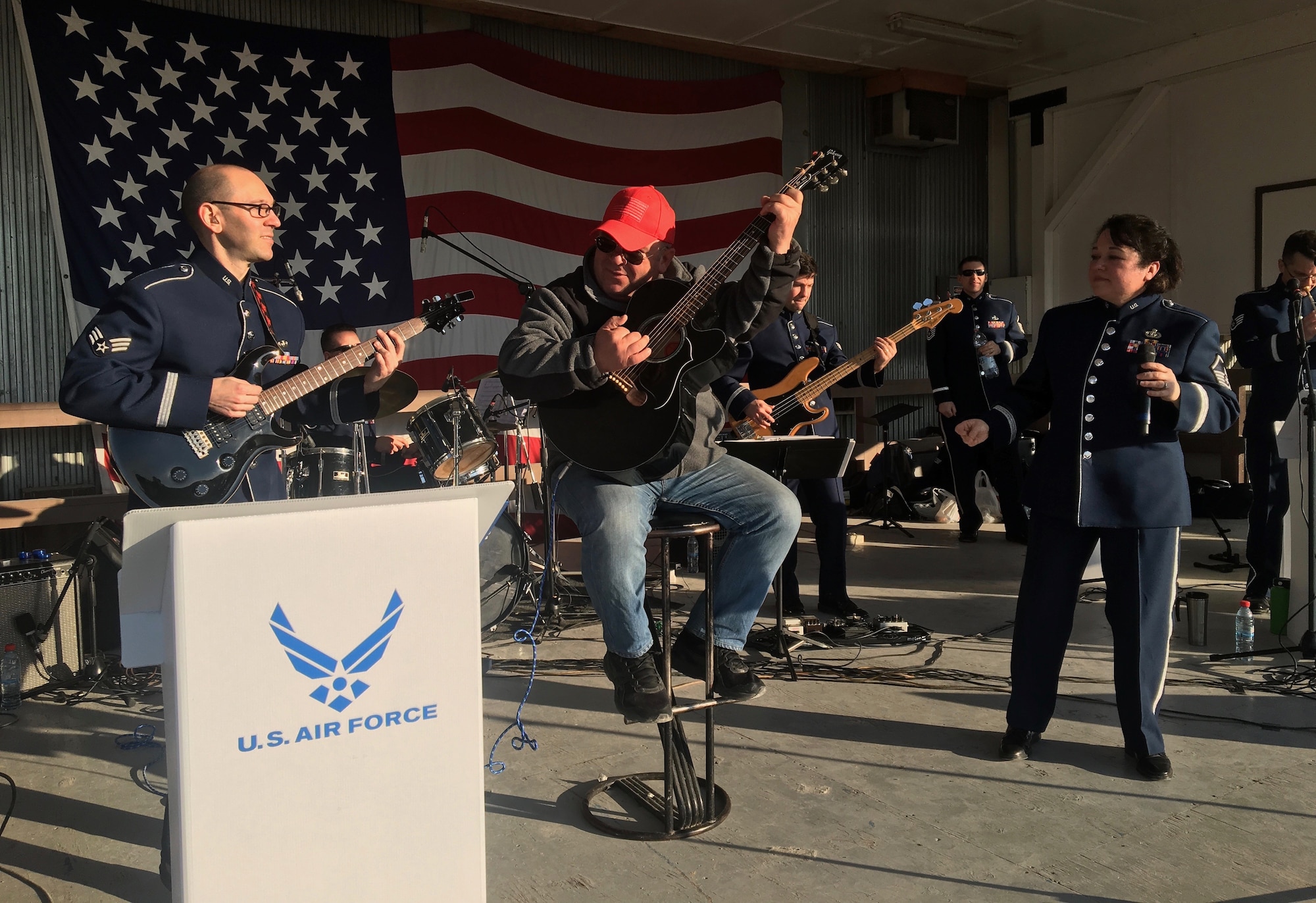 Local musician, Ilir Geci, joins the U.S. Air Forces in Europe Band onstage at Camp Bondsteel, Kosovo, for a rendition of “Jack and Diane,” Feb. 17, 2018. In addition to visiting NATO service members, the band was in Kosovo to celebrate the 10th anniversary of Kosovo independence. (U.S. Air Force by Maj. Tristan Hinderliter)