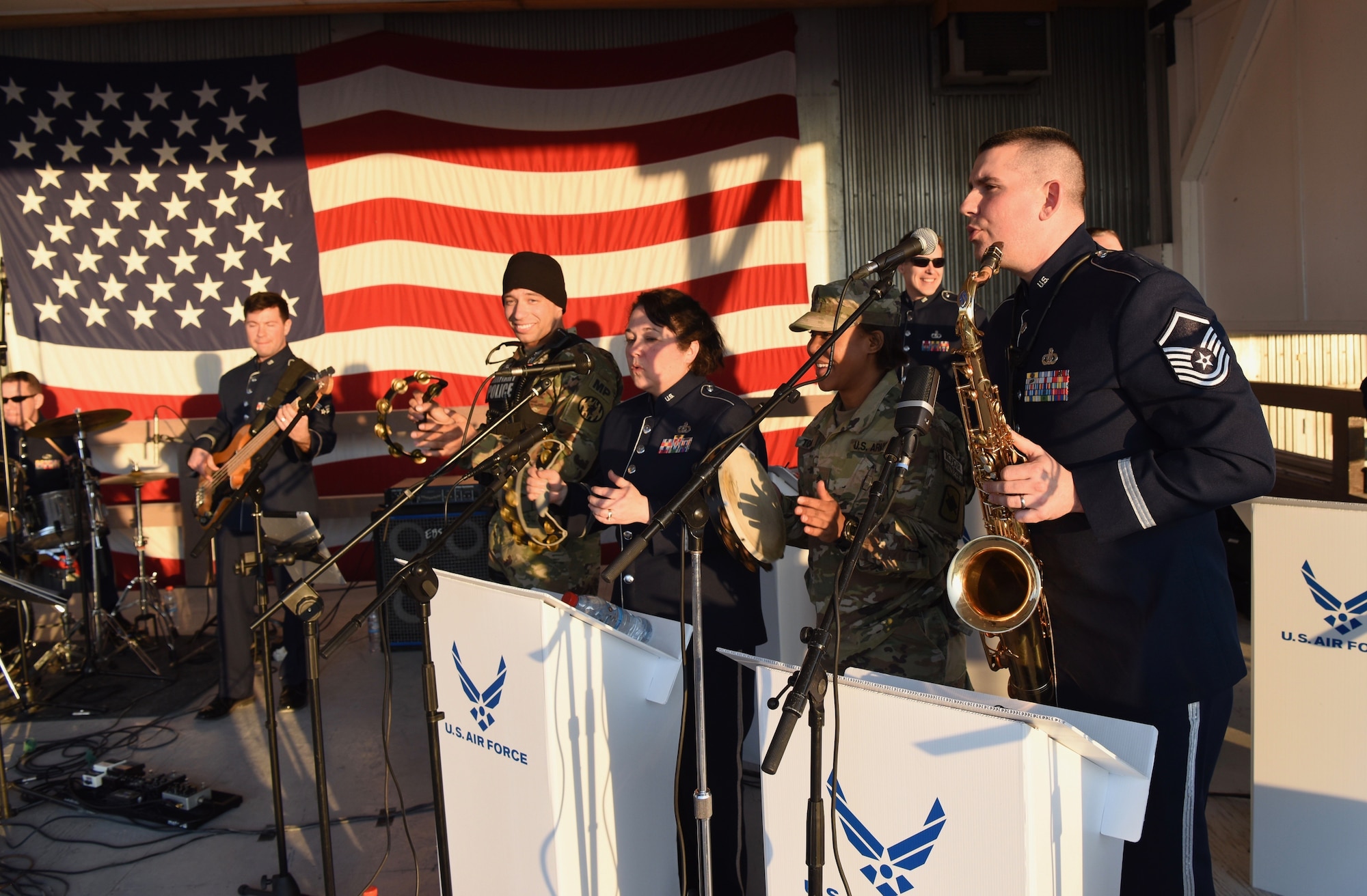 U.S. troops with Multinational Battle Group-East join the U.S. Air Forces in Europe Band onstage at Camp Bondsteel, Kosovo, Feb. 17, 2018. In addition to visiting NATO service members, the band was in Kosovo to celebrate the 10th anniversary of Kosovo independence. (U.S. Air Force photo by Maj. Tristan Hinderliter)