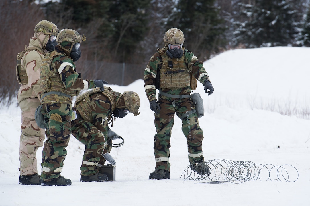 Airmen prepare an explosive charge before conducting a live-fire demolitions exercise.