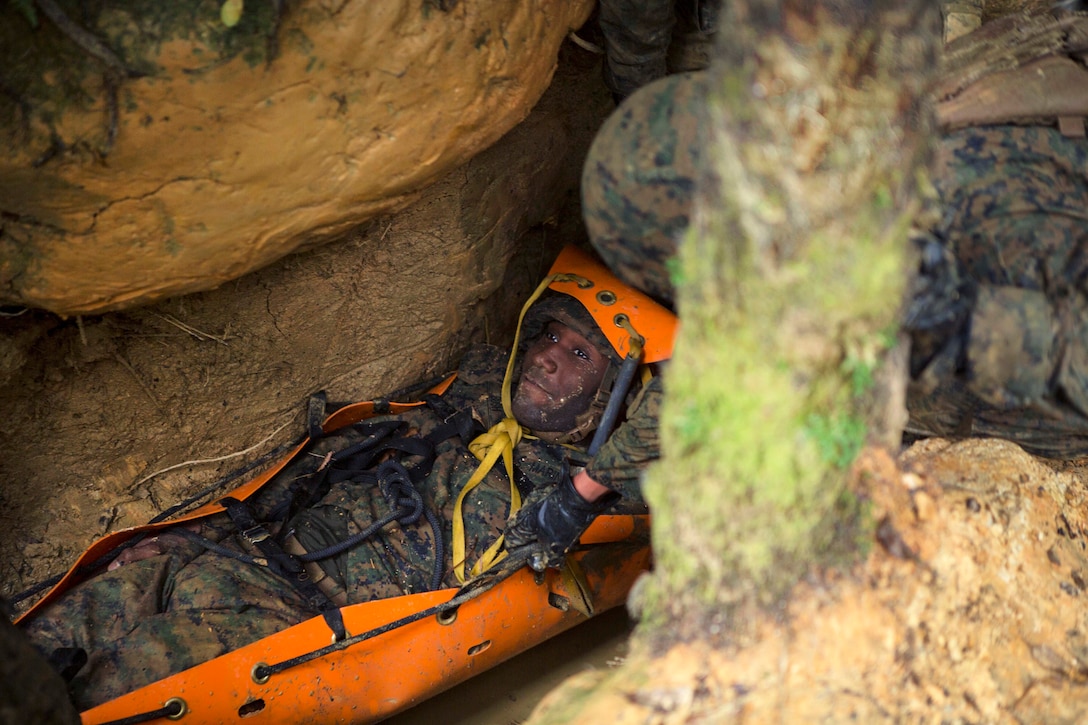 Marine Corps Lance Cpl. Daron Bush role-plays as a simulated casualty during the Endurance Course.