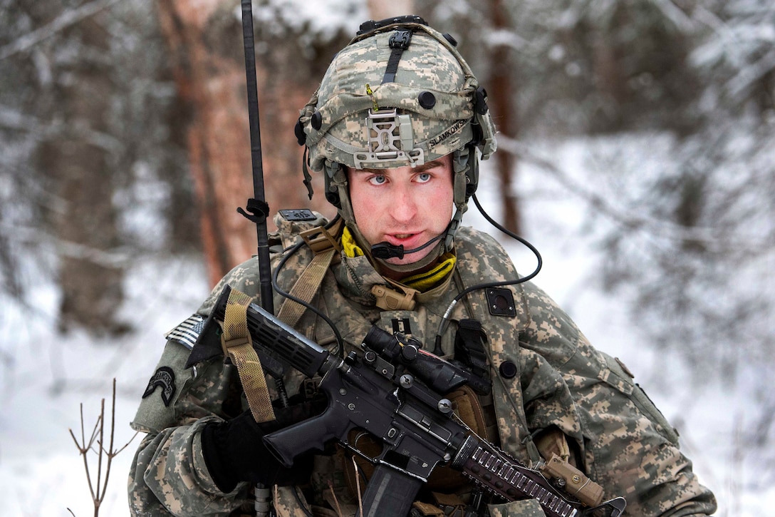 A soldier radios his headquarters to give an update on his company’s status.