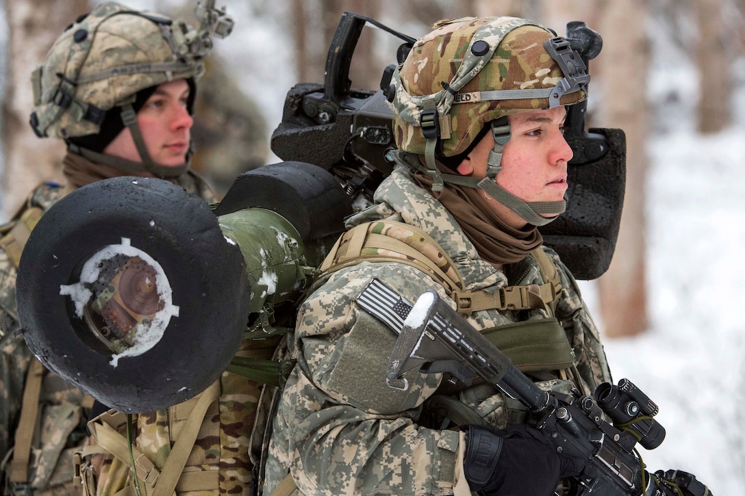 Soldiers maneuver to an assault position during a live-fire exercise.