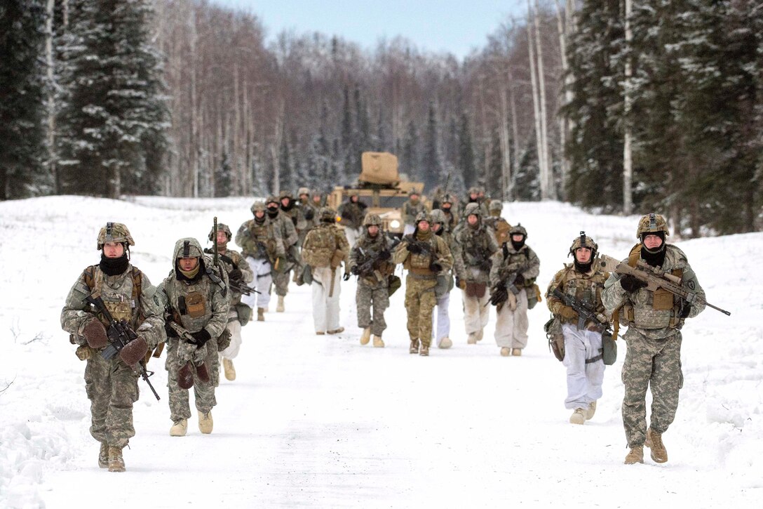 Soldiers march in the snow  to their next objective during a live-fire exercise.