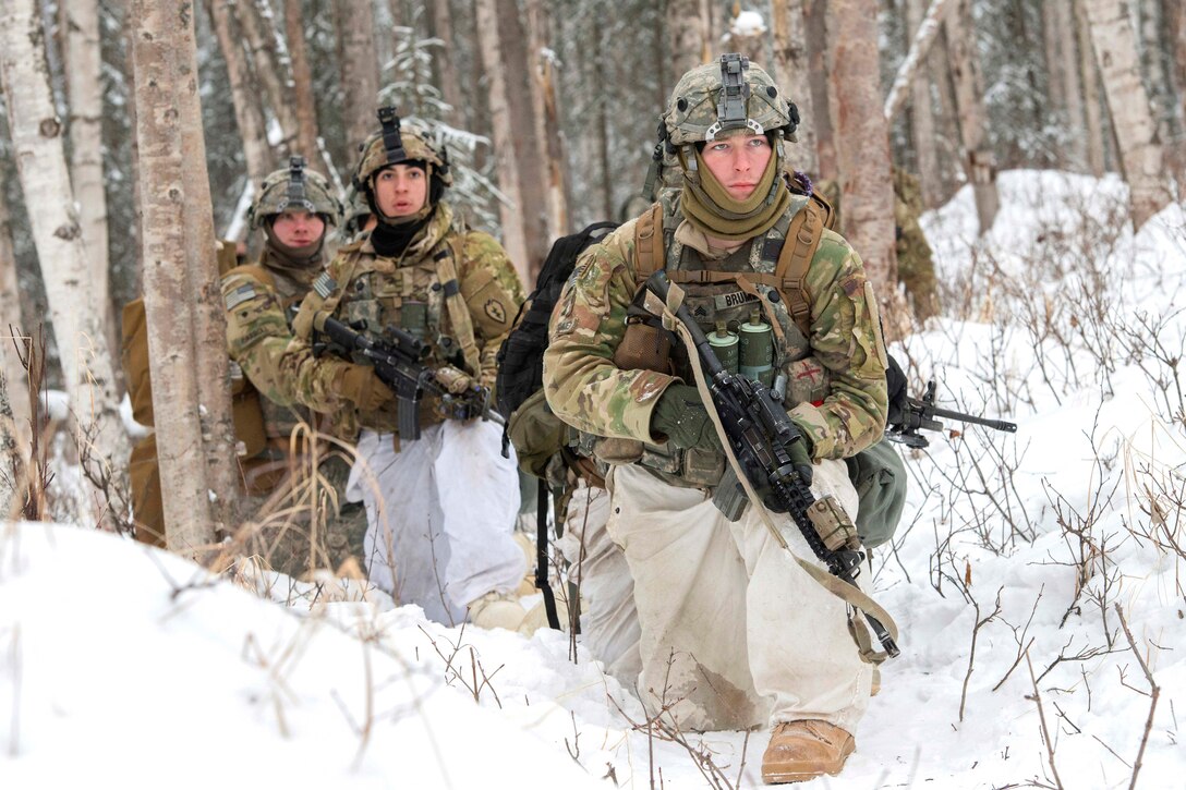 Soldiers prepare to assault a simulated enemy position.