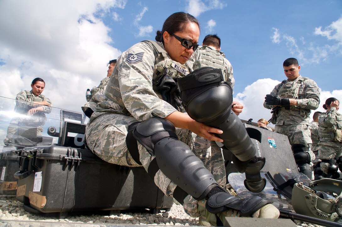 Hawaii Air National Guard Tech Sgt. Tashalynn Willing, a 154th Security Forces Squadron fire team member, puts on personal protective equipment during the Patriot South exercise at Camp Shelby, Miss.