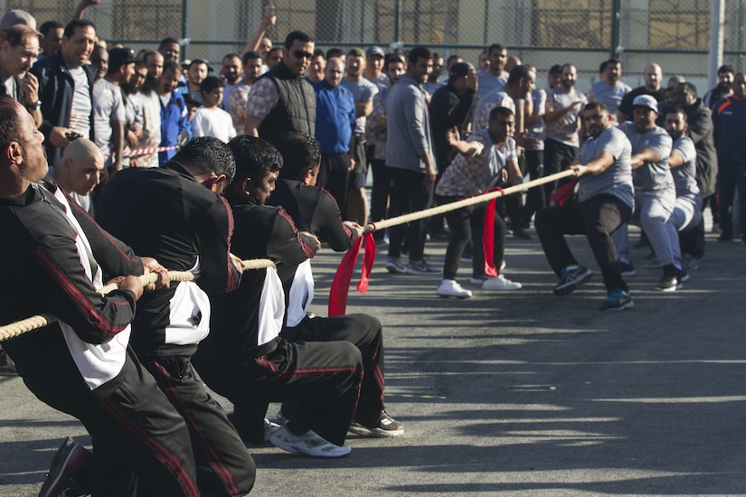 Teams of service members from the Qatar Armed Forces compete in tug-of-war.