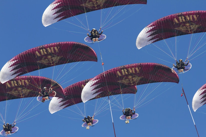 Powered paragliders from the Qatar Army perform during Qatar Armed Forces National Sport Day.