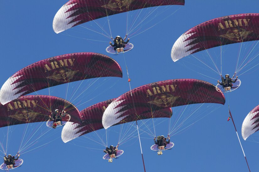 Powered paragliders from the Qatar Army perform during Qatar Armed Forces National Sport Day.