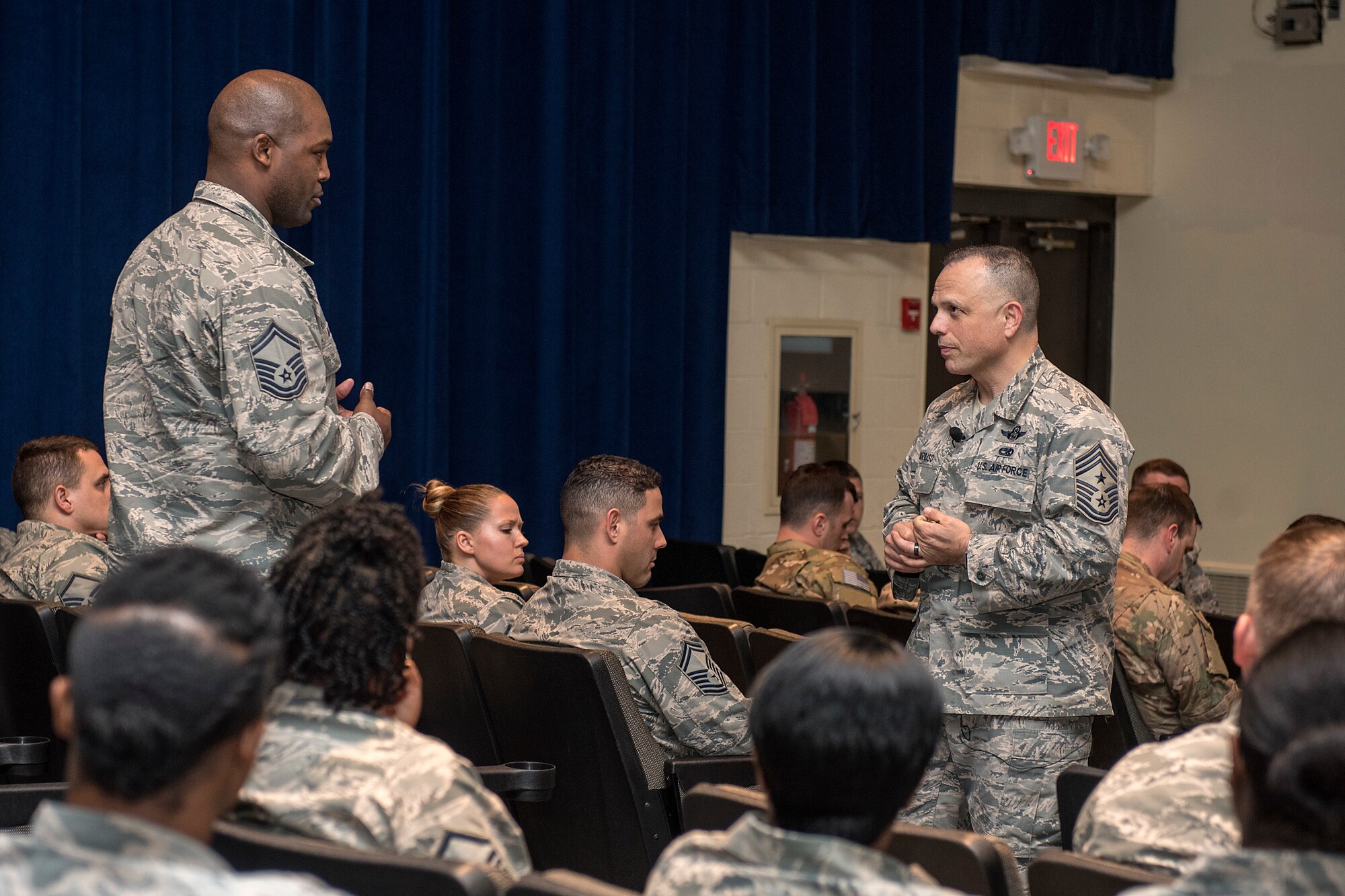 Senior Master Sgt. Marquis Daniels, 4th Security Forces Squadron, asks a question to Chief Master Sgt. Matthew Caruso, command senior enlisted leader of U.S. Transportation Command, during a senior NCO all call at the theater Feb. 15, 2018, at Seymour Johnson Air Force Base, North Carolina.