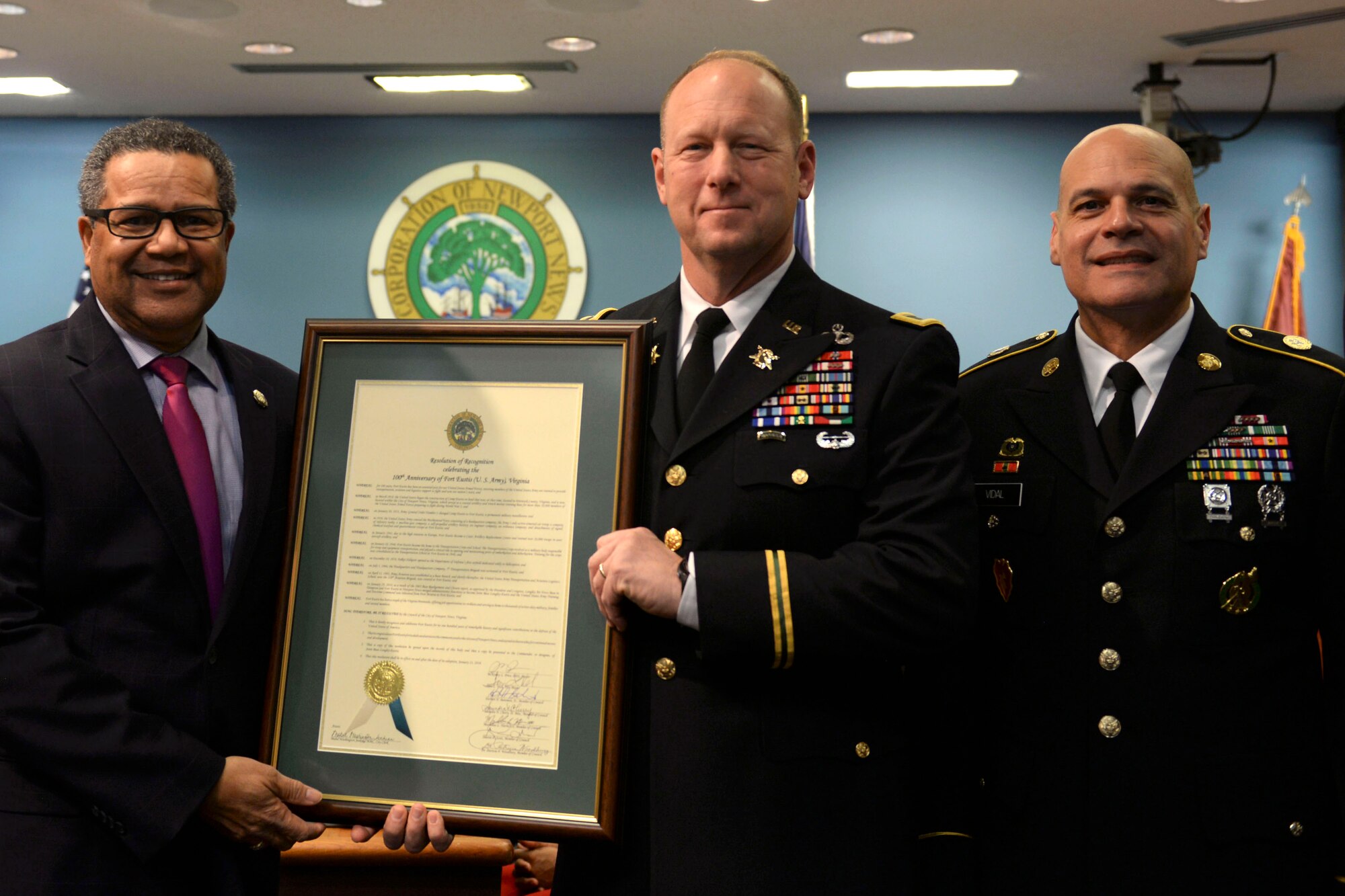 McKinley Price, Newport News, Va. mayor, presents U.S. Army Col. Ralph L. Clayton III, 733rd Mission Support Group commander, and U.S. Army Command Sgt. Maj. Eric J. Vidal, 733rd MSG command sergeant major, with a City Council Resolution of Recognition at Newport News City Council Chambers in Newport News, Feb. 13, 2018. The resolution was given to JBLE in honor of Fort Eustis' 100 years of dedicated service to the community and citizens of Newport News. (U.S. Air Force photo by Airman 1st Class Monica Roybal)