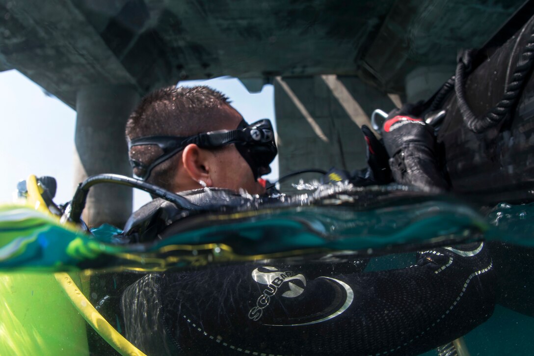 A Thai Navy diver prepares to dive during a pier assessment.