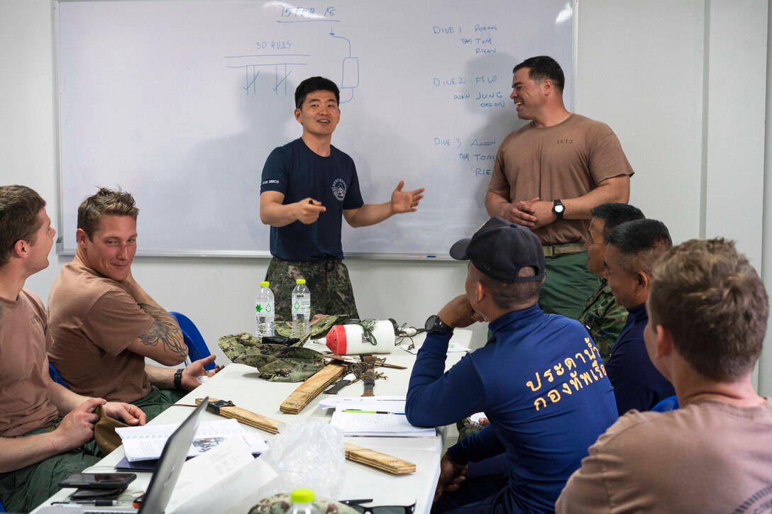 A South Korean navy officer speaks with U.S. and Thai navy divers at the Thai Navy Diving School.