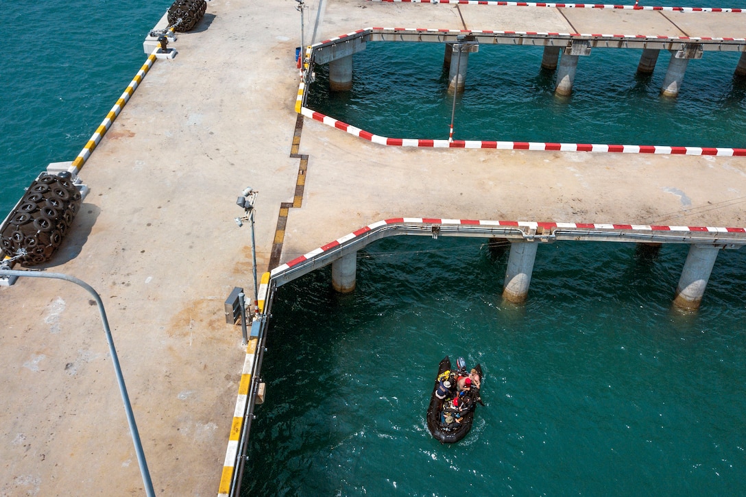 U.S. Navy divers prepare to dive during a pier assessment.