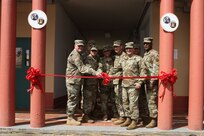 Maj. Gen. Bruce Hackett, commanding General of the 80th Training Command, and Brig. Gen. Hector Lopez, commanding general of the 94th Training Division, take part in the ribbon-cutting ceremony at Fort Buchanan, Puerto Rico to celebrate the reopening and relocation of a schoolhouse for the 94th Training Division's 5th Battalion on 13 February 2018. The 5th BN's previous schoolhouse was severely damaged by the devastation of Hurricane Maria. Maj. Gen. Hackett and Brig. Gen. Lopez were also on the island to assist with the planned tranistion and approved reassignment of all units stationed in Puerto Rico to the operational control of the 1st Mission Support Command.

Photo by Army Master Sgt. Benari Poulten, 80th Training Command (TASS) Public Affairs