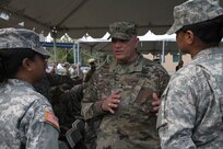 Maj. Gen. Bruce Hackett, commanding General of the 80th Training Command speaks with Soldiers at the ribbon-cutting ceremony at Fort Buchanan, Puerto Rico to celebrate the reopening and relocation of a schoolhouse for the 94th Training Division's 5th Battalion on 13 February 2018. The 5th BN's previous schoolhouse was severely damaged by the devastation of Hurricane Maria. Maj. Gen. Hackett and Brig. Gen. Hector Lopez, commanding general of the 94th Training Division, were also on the island to assist with the planned tranistion and approved reassignment of all units stationed in Puerto Rico to the operational control of the 1st Mission Support Command.

Photo by Army Master Sgt. Benari Poulten, 80th Training Command (TASS) Public Affairs