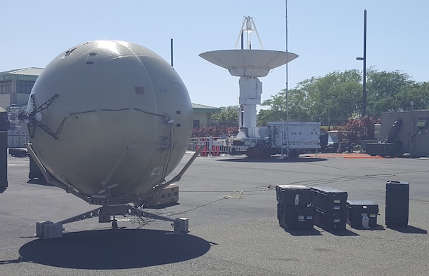 With support from the Air Force Small Business Innovation Research/Small Business Technology Transfer Program, GATR Technologies developed a portable antenna with tracking capability. Shown here (in the foreground), the GATR TRAC packs into cases that are easy to transport compared to traditional antenna systems such as the one shown in the background. (Photo courtesy of GATR Technologies)