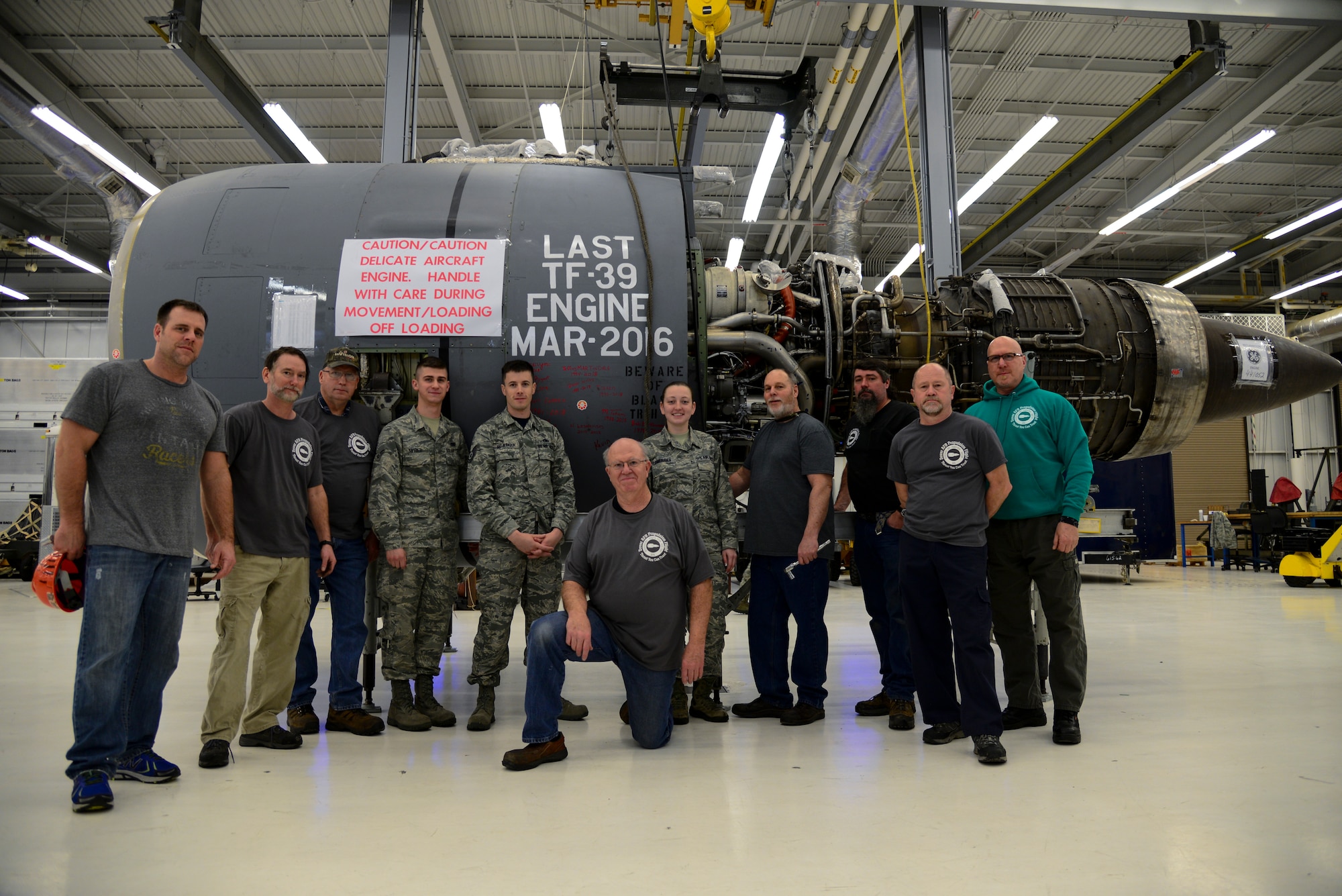 Members of the legacy 436th Maintenance Squadron Jet Engine Intermediate Level Maintenance Shop stand in front of the last General Electric TF-39 turbofan engine used and owned by the Air Force during a brief ceremony Feb. 16, 2018, at Dover Air Force Base, Del. The members of the shop bid farewell to the final TF-39 engine built at the shop and the last one owned by the Air Force. (U.S. Air Force photo by Staff Sgt. Aaron J. Jenne)
