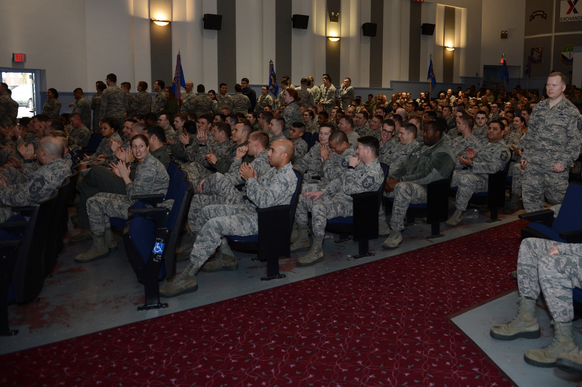 Team McChord Airmen and family members clap during the newly revived enlisted promotion ceremony, Jan. 30, 2018, at Joint Base Lewis-McChord, Wash.