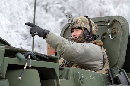 Army 1st Lt. Daniel Choi, assigned to Bayonet Company, 1st Battalion, 5th Infantry Regiment, 1st Stryker Brigade Combat Team, 25th Infantry Division, U.S. Army Alaska, directs his Stryker armored vehicle while preparing for live-fire gunnery training during Operation Punchbowl at Joint Base Elmendorf-Richardson, Alaska, Feb. 16, 2018. Operation Punchbowl was a battalion-level, combined arms, live-fire exercise that focused on arctic lethality.