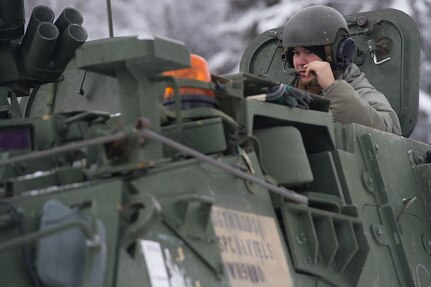 A vehicle commander assigned to the 1st Battalion, 5th Infantry Regiment, 1st Stryker Brigade Combat Team, 25th Infantry Division, U.S. Army Alaska, speaks into his head set as he prepares for gunnery on Joint Base Elmendorf-Richardson, Alaska, during Operation Punch Bowl. The Fort Wainwright based Soldiers' operation culminated with multiple live-fire and combat training events.