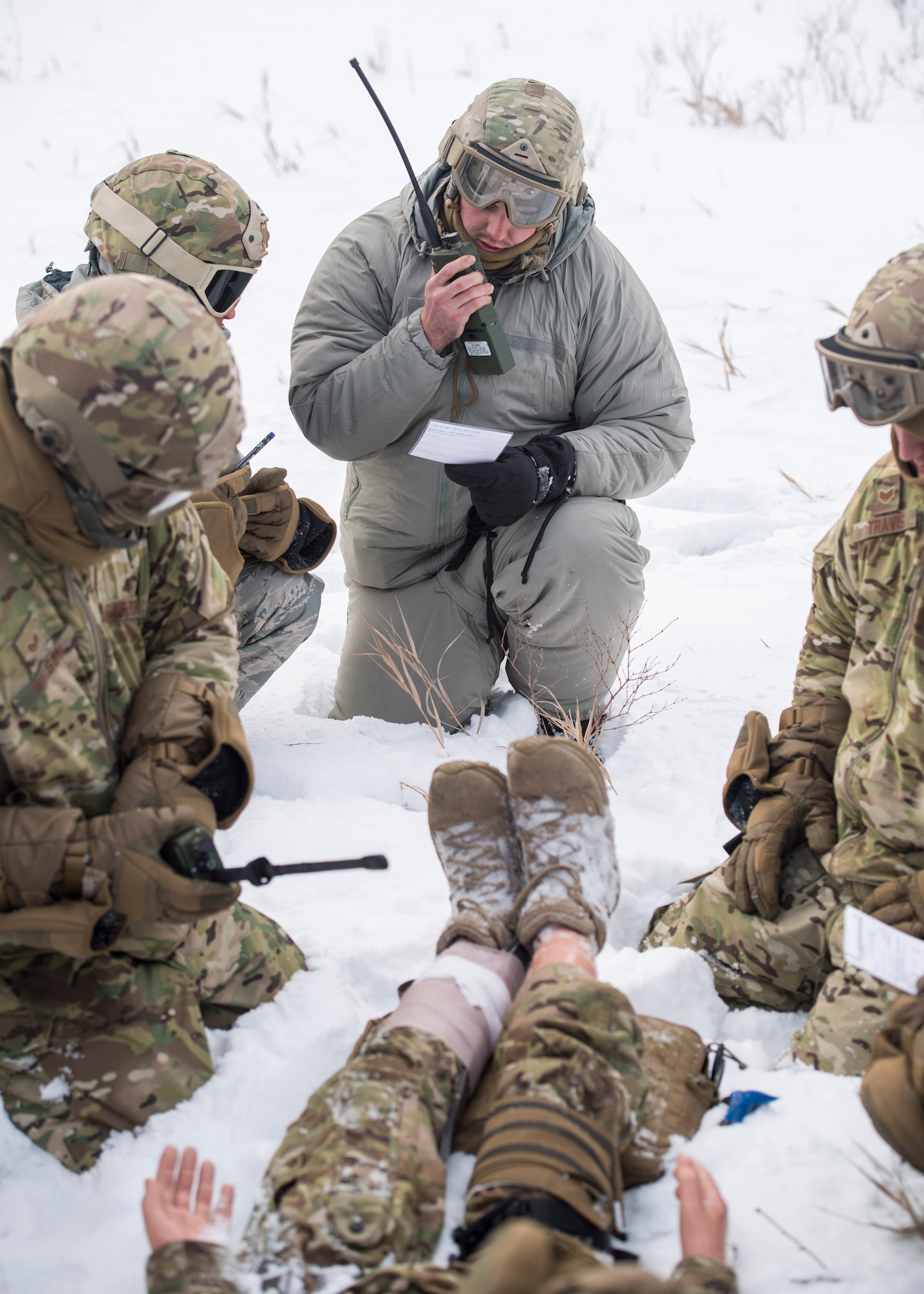Members of the 91st Security Forces Group perform self-aid buddy care on a simulated casualty in the Turtle Mountain State Forest, N.D., Feb. 14, 2018. After stabilizing the casualty, defenders vectored in a rescue helicopter for an emergency medical evacuation. (U.S. Air Force photo by Senior Airman J.T. Armstrong)