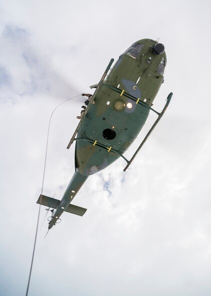 A 54th Helicopter Squadron UH-1N Iroquois hovers above the Turtle Mountain State Forest, N.D., Feb. 14, 2018, during a 91st Security Forces Group field training exercise. During the FTX, the 54th HS coordinated with defenders to drop a forest penetrator and lift an Airman. (U.S. Air Force photo by Senior Airman J.T. Armstrong)