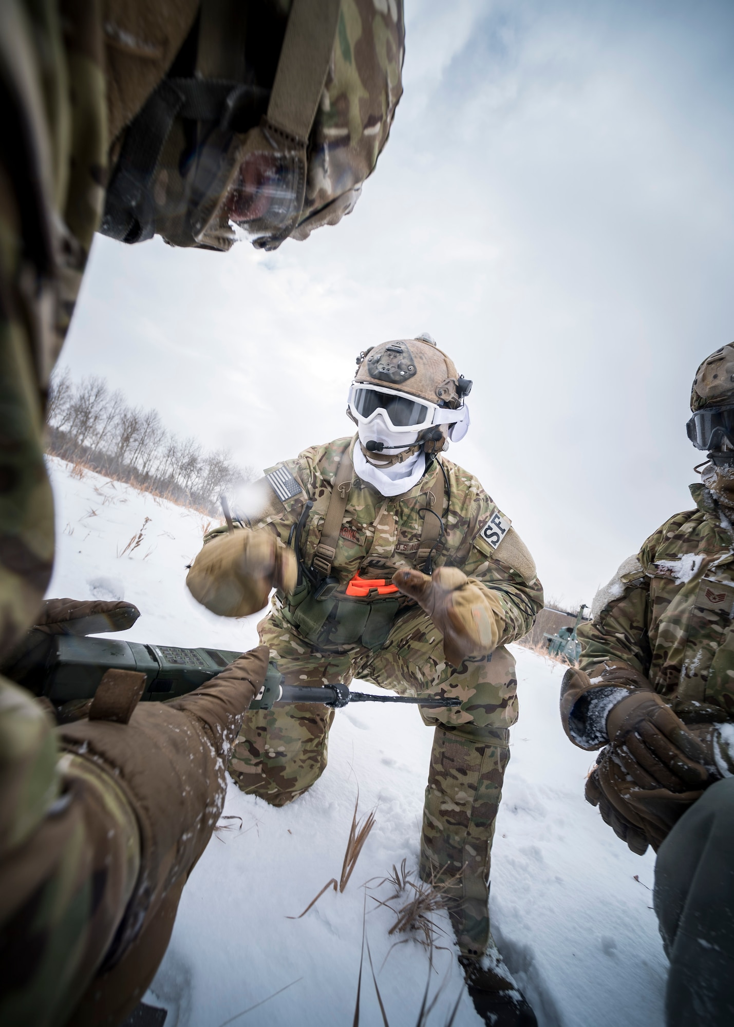 Defenders from the 91st Security Forces Group vector in a helicopter in the Turtle Mountain State Forest, N.D., Feb. 14, 2018, during a 91st Security Forces Group field training exercise. During the FTX, defenders vectored the aircraft to the landing zone and performed a simulated emergency medical evacuation. (U.S. Air Force photo by Senior Airman J.T. Armstrong)
