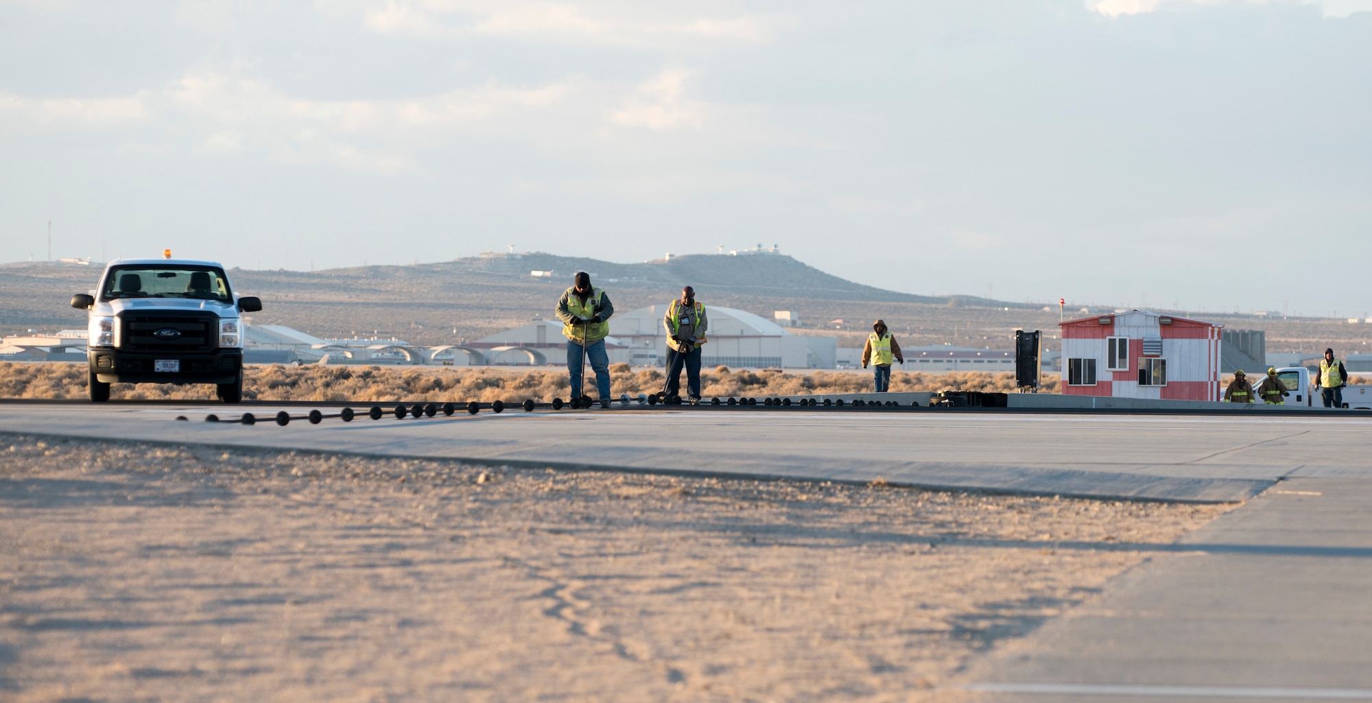 An Edward F-16 catches the arresting cable on an Edwards runway as part of a certification engagement of a newly overhauled aircraft arresting system Jan. 25. Members of the 412th Civil Engineer Squadron began installing the new system last November. (U.S. Air Force photo by Brad White)