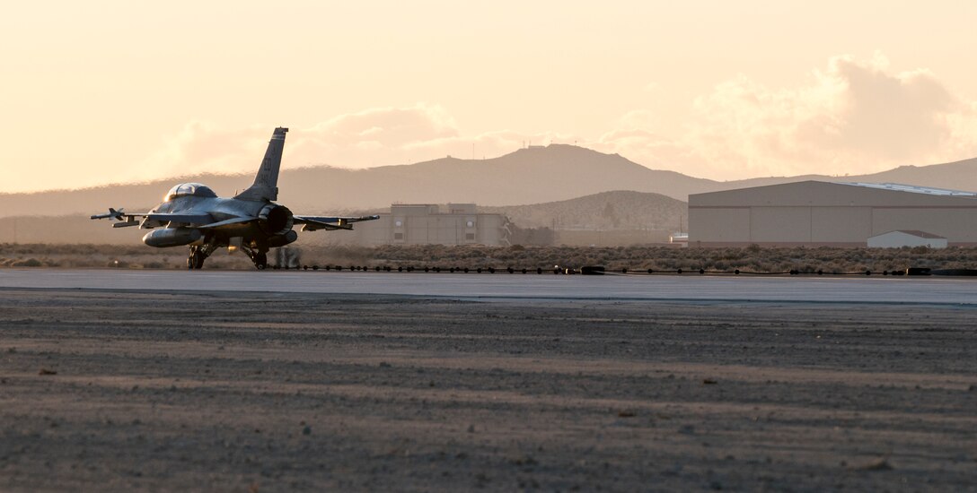 An Edward F-16 catches the arresting cable on an Edwards runway as part of a certification engagement of a newly overhauled aircraft arresting system Jan. 25. Members of the 412th Civil Engineer Squadron began installing the new system last November. (U.S. Air Force photo by Brad White)