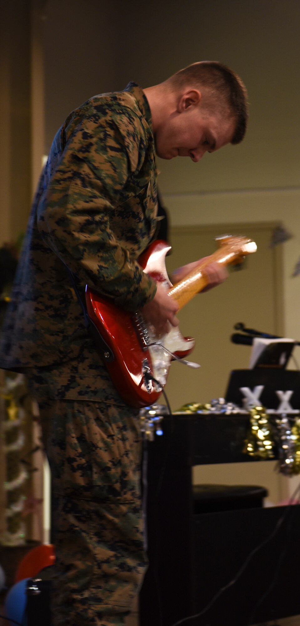 U.S. Marine Corps. Pfc. Connor Morgan, Marine Corps Detachment trainee, performs a guitar solo during the 11th Annual Talent Show at the Crossroads on Goodfellow Air Force Base, Texas, Feb. 16, 2018. The Talent Show was open to the trainees from Goodfellow and gave them a chance to find out who is the best on base. (U.S. Air Force Photo by Airman 1st Class Zachary Chapman/Released)