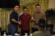 U.S. Air Force Col. Ricky Mills, 17th Training Wing commander awards Airman Ryan Marquez, 312th Training Squadron trainee, and Airman Dalton Neff, 312th TRS trainee, with the 3rd place trophy during the 11th Annual Talent Show at the Crossroads on Goodfellow Air Force Base, Texas, Feb. 16, 2018. Marquez and Neff played the guitar and kahan to the song ‘You and Me’ by Lifehouse. (U.S. Air Force Photo by Airman 1st Class Zachary Chapman/Released)