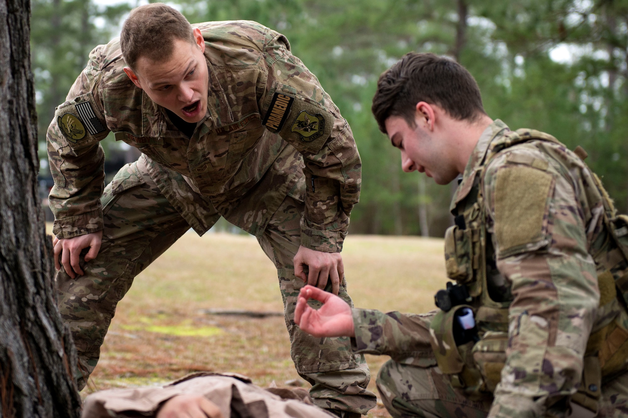 Staff Sgt. Cory Newby, left, 347th Operations Support Squadron (OSS) independent duty medical technician paramedic, yells at Airman 1st Class Elijah Bishop, 347th OSS intelligence analyst, during a Tactical Combat Casualty Care course, Feb. 14, 2018, at Moody Air Force Base, Ga. The training is designed to teach Airmen how to apply critical life-saving skills while engaged in a combat environment. (U.S. Air Force photo by Airman 1st Class Erick Requadt)