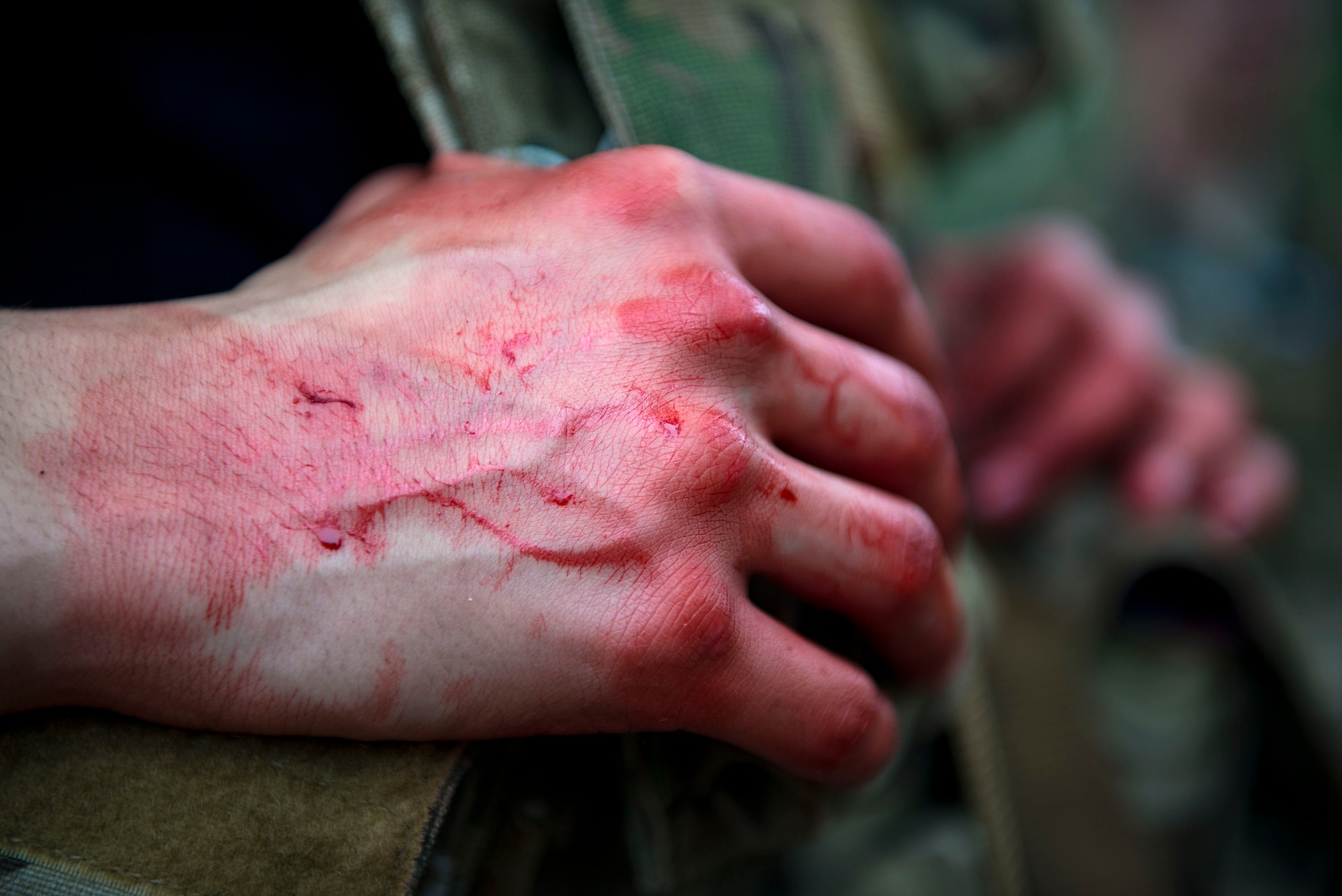 Fake blood rests on the hands of Airman 1st Class Andruw Reyes, 23d Maintenance Squadron nondestructive inspection technician, during a Tactical Combat Casualty Care course, Feb. 14, 2018, at Moody Air Force Base, Ga. The training is designed to teach Airmen how to apply critical life-saving skills while engaged in a combat environment. (U.S. Air Force photo by Airman 1st Class Erick Requadt)
