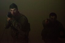 Airman 1st Class Elijah Bishop, left, 347th Operations Support Squadron intel analyst, and Capt. John Golding, 41st Rescue Squadron director of staff, secure a room during a Tactical Combat Casualty Care course, Feb. 14, 2018, at Moody Air Force Base, Ga. The training is designed to teach Airmen how to apply critical life-saving skills while engaged in a combat environment. (U.S. Air Force photo by Airman 1st Class Erick Requadt)