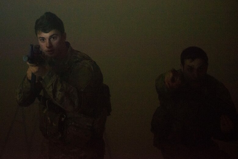 Airman 1st Class Elijah Bishop, left, 347th Operations Support Squadron intel analyst, and Capt. John Golding, 41st Rescue Squadron director of staff, secure a room during a Tactical Combat Casualty Care course, Feb. 14, 2018, at Moody Air Force Base, Ga. The training is designed to teach Airmen how to apply critical life-saving skills while engaged in a combat environment. (U.S. Air Force photo by Airman 1st Class Erick Requadt)