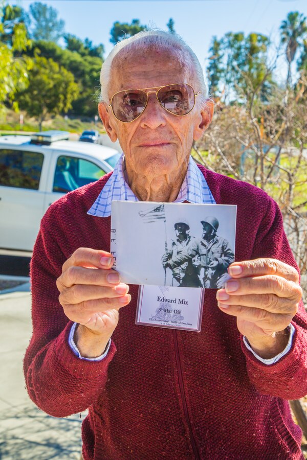 Retired U.S. Marine Corps Sergeant Edward Mix, a 5th Marine Division Iwo Jima Veteran, shares a photograph taken during the Battle of Iwo Jima at a tour of Marine Corps Base Camp Pendleton in commemoration of the 73d Anniversary of the Battle of Iwo Jima, Feb 15, 2018. Iwo Jima was a major World War II battle in which the United States Marine Corps landed on and eventually captured the island of Iwo Jima from the Japanese Imperial Army. Veterans of the battle and their family members were invited to Camp Pendleton for a tour which included a special reaction team static display, Meal Ready to Eat sampling, and a tour of the Assault Craft Unit-5. (U.S. Marine Corps Photo by Pfc. Kerstin Roberts)