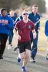 Participants of the St. Valentine’s Day 5k/10k approach the halfway point Feb. 14, 2018, at Dover Air Force Base, Del. The course ran along the perimeter of the base and ended back at the fitness center. (U.S. Air Force photo by Mauricio Campino)