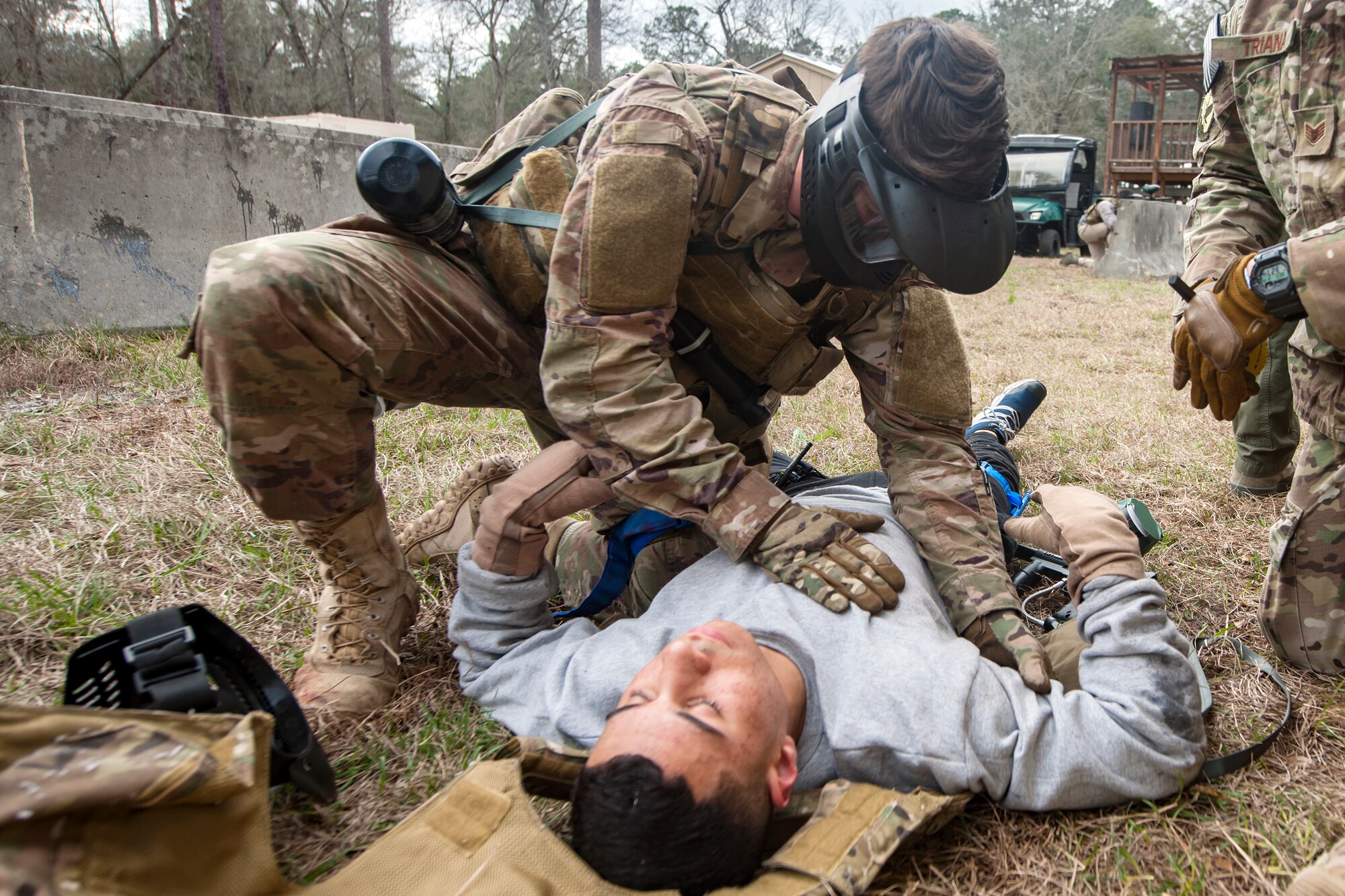 Airman 1st Class Elijah Bishop, 347th Operations Support Squadron intelligence analyst, top, examines Airman 1st Class Andruw Reyes, 23d Maintenance Squadron non-destructive inspection apprentice, Feb. 14, 2018, at Moody Air Force Base, Ga.  Airmen participated in a Tactical Combat Casualty Care (TCCC) course to better prepare themselves to combat an enemy attack while still being able to apply medical care under enemy fire.
 (U.S. Air Force photo by Airman Eugene Oliver)
