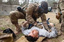 Airman 1st Class Elijah Bishop, 347th Operations Support Squadron intelligence analyst, top, examines Airman 1st Class Andruw Reyes, 23d Maintenance Squadron non-destructive inspection apprentice, Feb. 14, 2018, at Moody Air Force Base, Ga.  Airmen participated in a Tactical Combat Casualty Care (TCCC) course to better prepare themselves to combat an enemy attack while still being able to apply medical care under enemy fire.
 (U.S. Air Force photo by Airman Eugene Oliver)