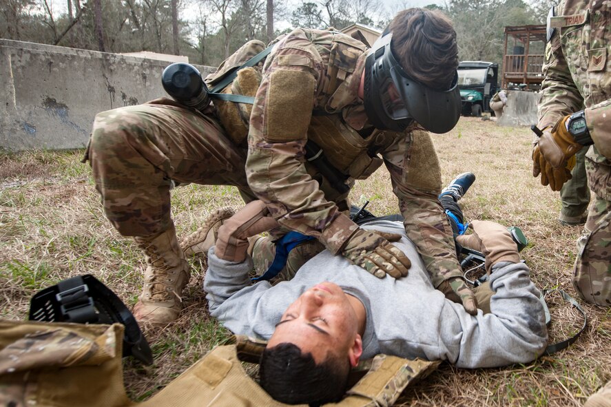 Airman 1st Class Elijah Bishop, 347th Operations Support Squadron intelligence analyst, top, examines Airman 1st Class Andruw Reyes, 23d Maintenance Squadron non-destructive inspection apprentice, Feb. 14, 2018, at Moody Air Force Base, Ga.  Airmen participated in a Tactical Combat Casualty Care (TCCC) course to better prepare themselves to combat an enemy attack while still being able to apply medical care under enemy fire.
 (U.S. Air Force photo by Airman Eugene Oliver)