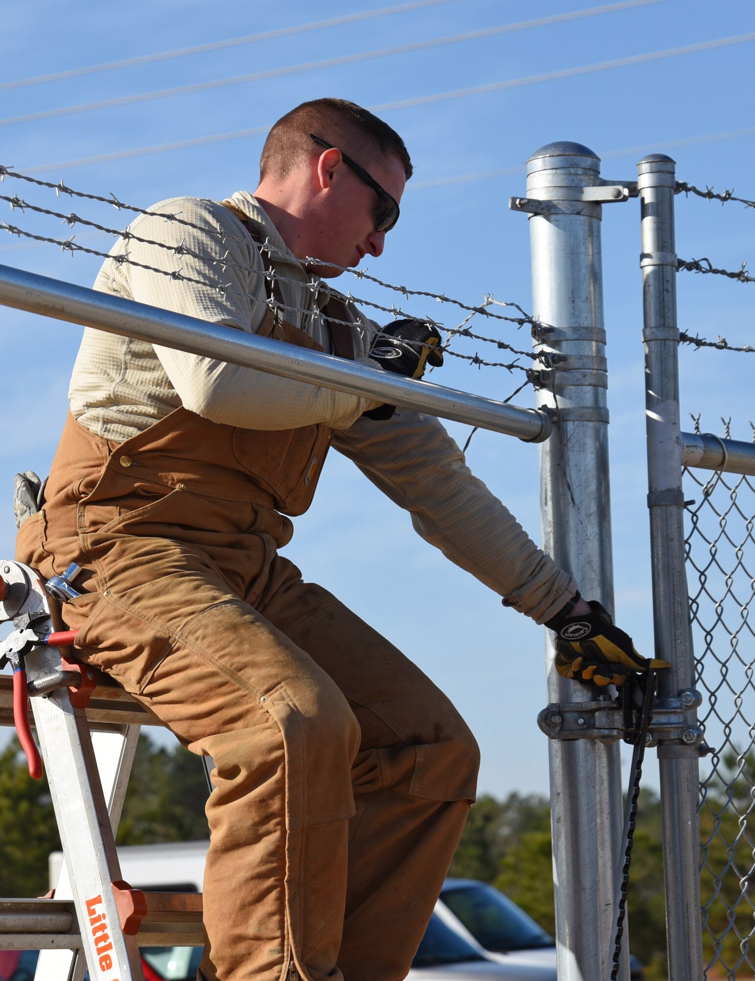 A U.S. Airman assigned to the 20th Civil Engineer Squadron constructs a fence for a new MQ-9 site at Shaw Air Force Base, S.C., Dec. 12, 2018.