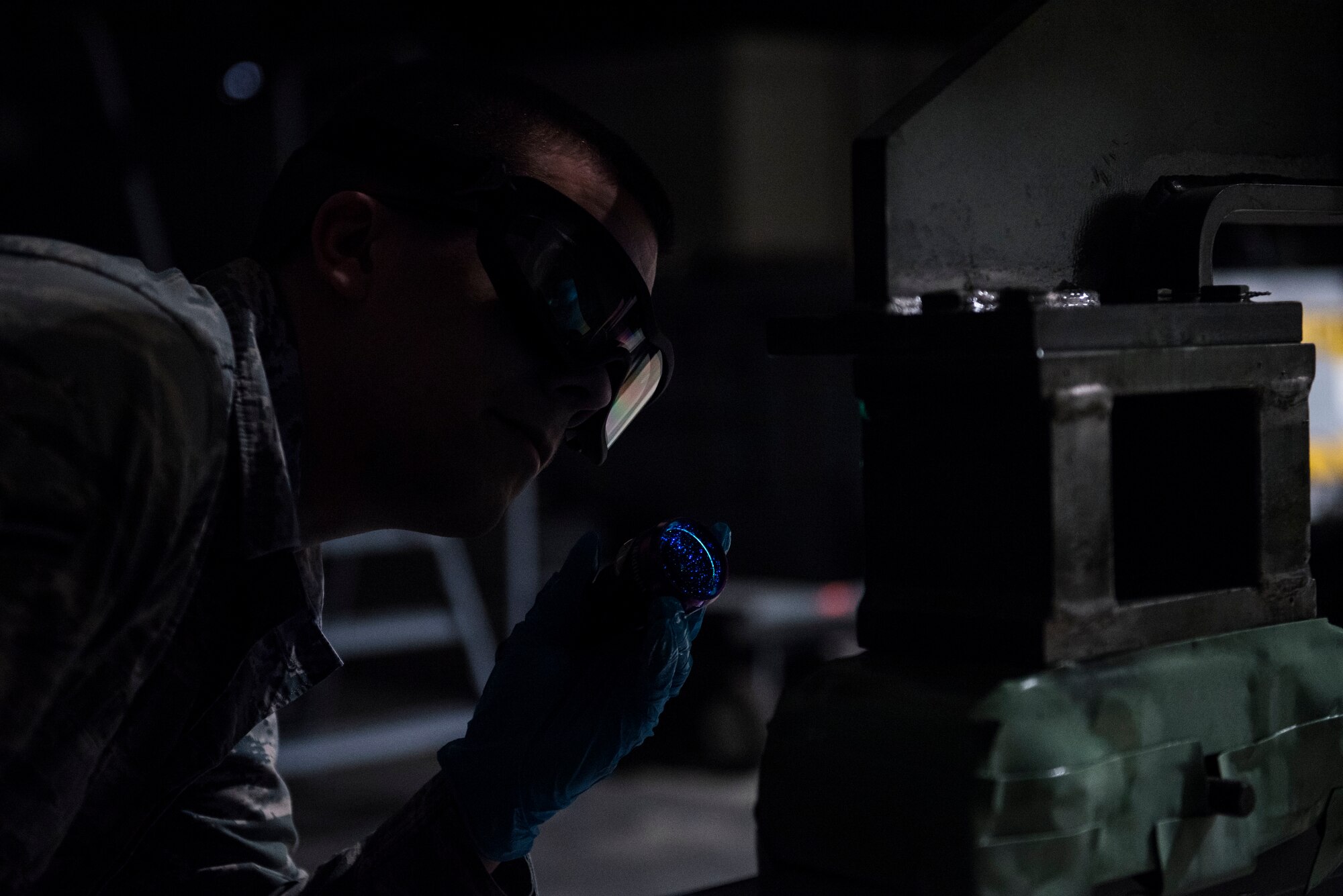 U.S. Air Force Airman 1st Class Jerod Rice, 20th Equipment Maintenance Squadron nondestructive inspection apprentice, uses a blacklight to search for flaws in the structural integrity of a halo at Shaw Air Force Base, S.C., Feb. 13, 2018.
