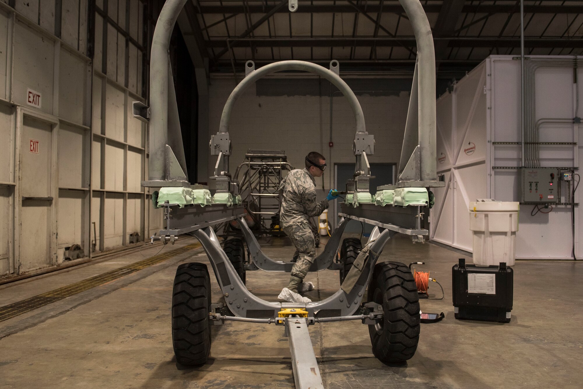 U.S. Air Force Airman 1st Class Jerod Rice, 20th Equipment Maintenance Squadron nondestructive inspection apprentice, sprays fluorescent magnetic particle spray onto a halo at Shaw Air Force Base, S.C., Feb. 13, 2018.
