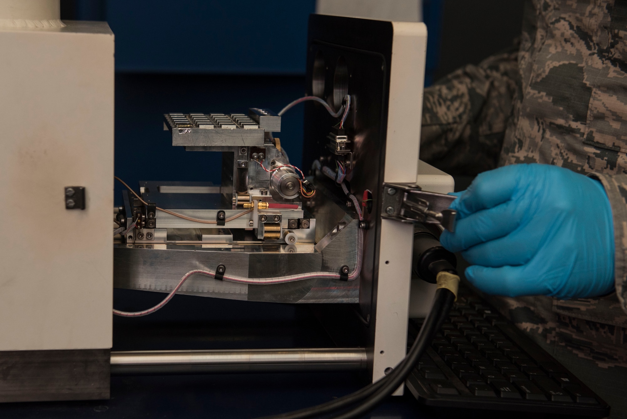 U.S. Air Force Senior Airman Eric Corrado, 20th Equipment Maintenance Squadron nondestructive inspection journeyman, closes the drawer to a JetScan machine at Shaw Air Force Base, S.C., Feb. 13, 2018.
